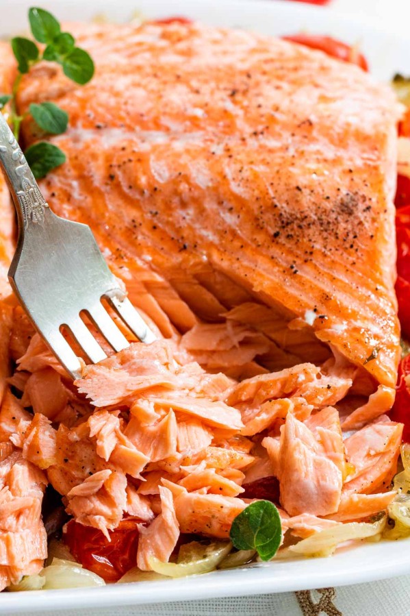 a salmon fillet flaked up with a fork.
