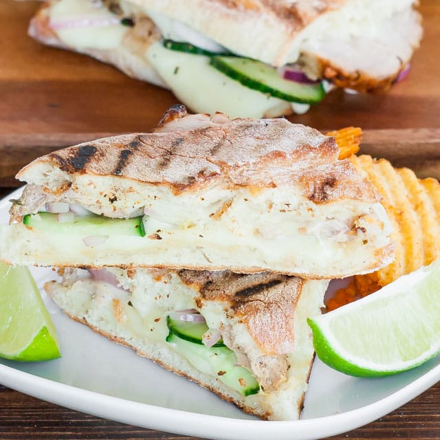 Cuban Panini with Quick Pickles with lime wedges as garnish