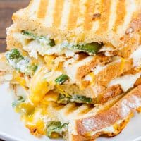 side view shot of 4 jalapeno popper grilled cheese stacked on top of each other