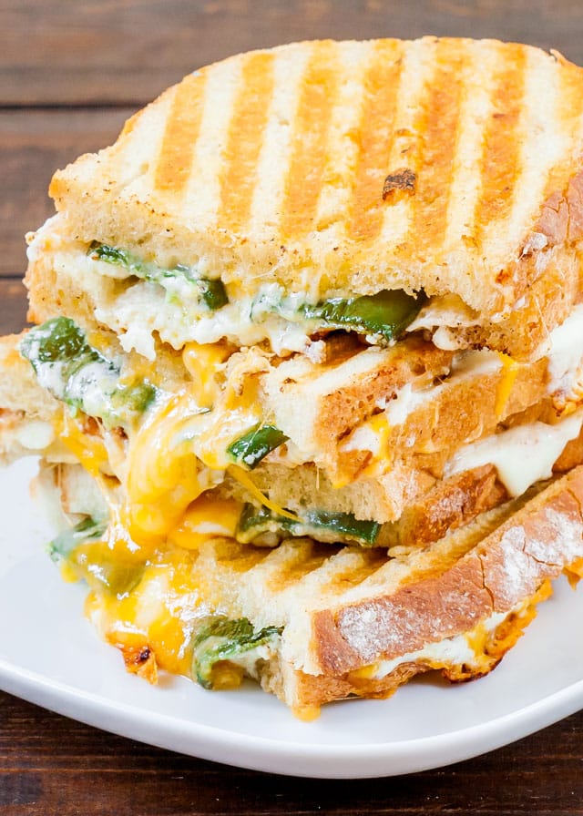 side view shot of 4 jalapeno popper grilled cheese stacked on top of each other