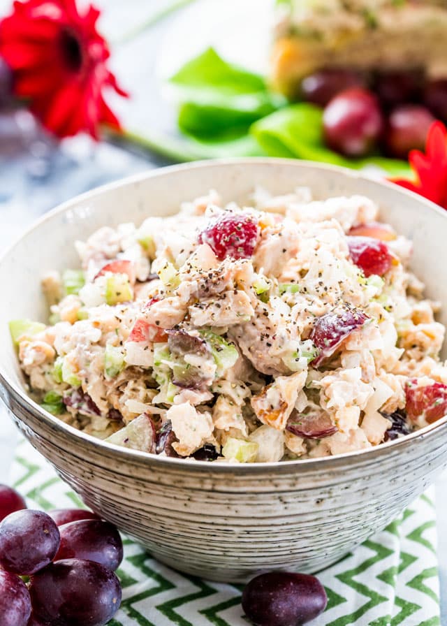 a bowl filled with chicken salad with grapes