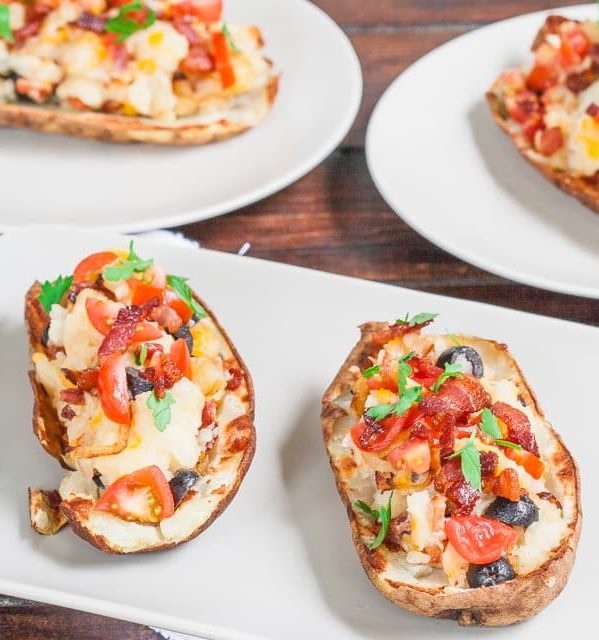 two loaded potato skins on a plate