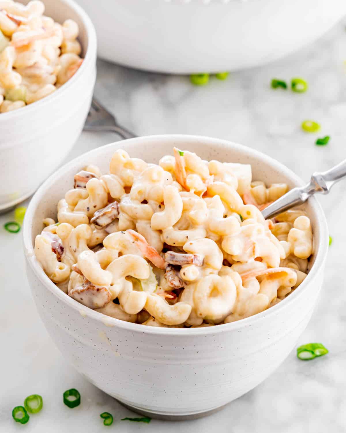 two small bowls loaded with macaroni salad