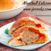 meatball calzone cut in half exposing the center