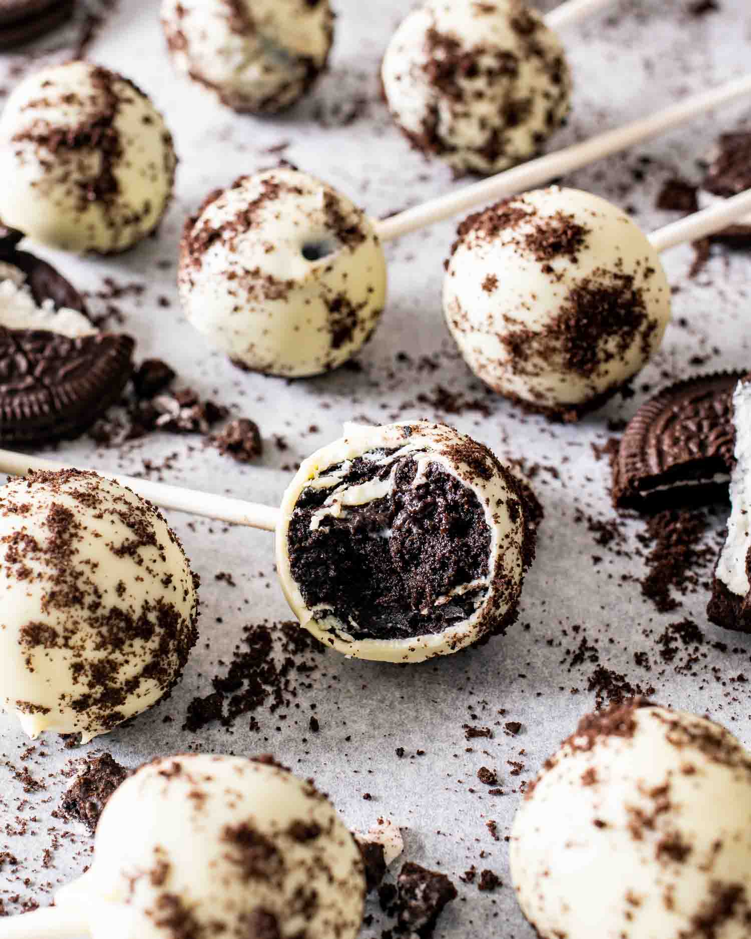 a bunch of beautiful no bake oreo cake pops arranged on a table.