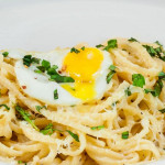 a bowl of lazy linguini topped with a quail egg