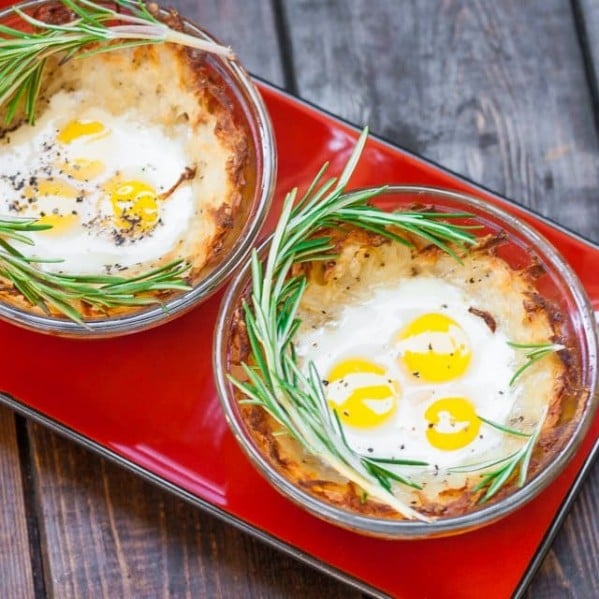 quail eggs in hashbrown nests garnished with fresh rosemary
