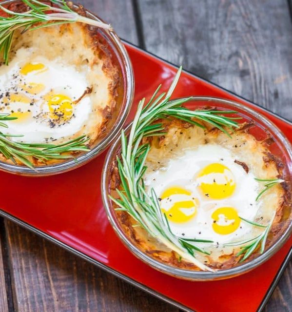 quail eggs in hashbrown nests garnished with fresh rosemary