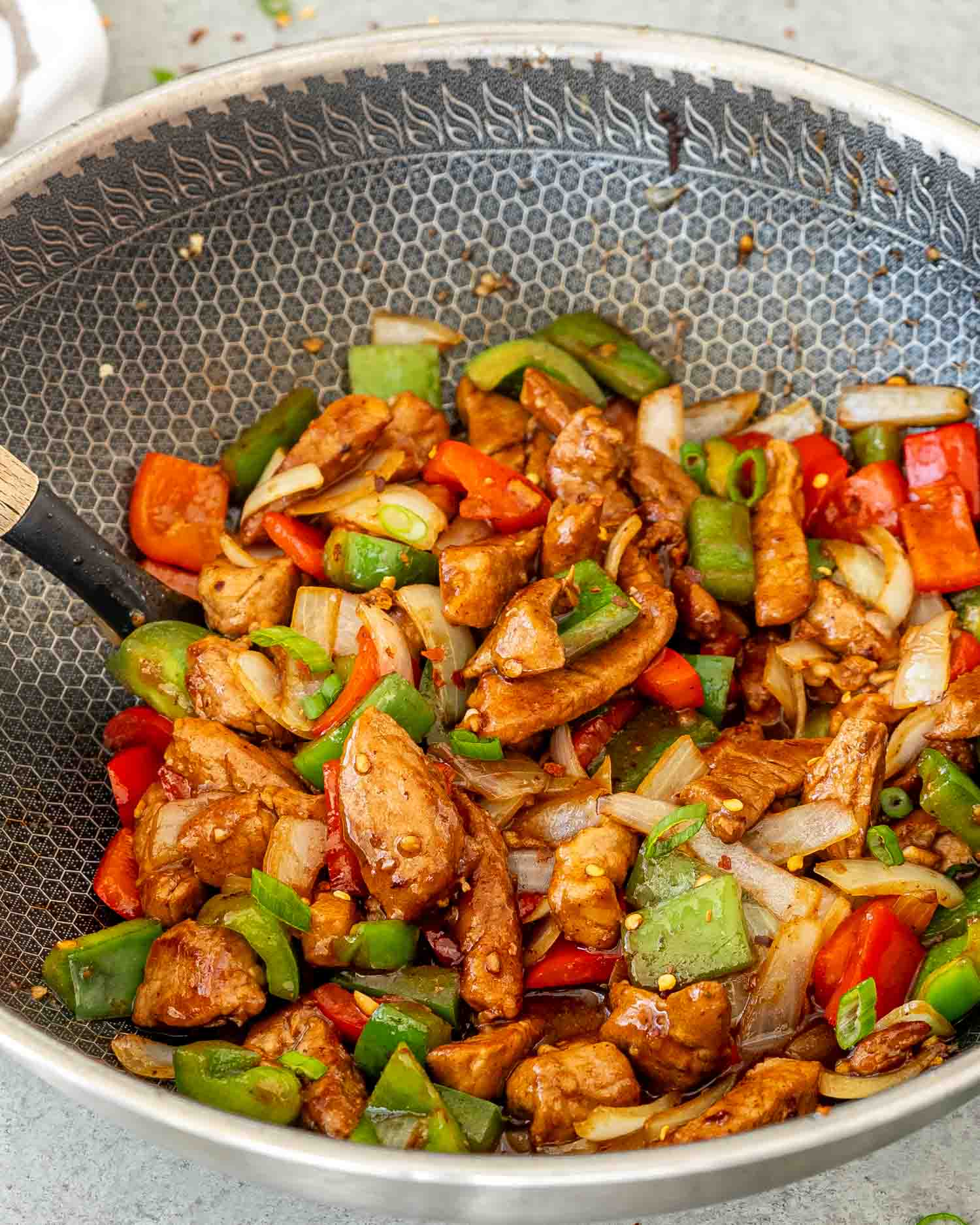 hot off the stove szechuan pork in a wok.