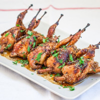 a plate of asian style roasted quail
