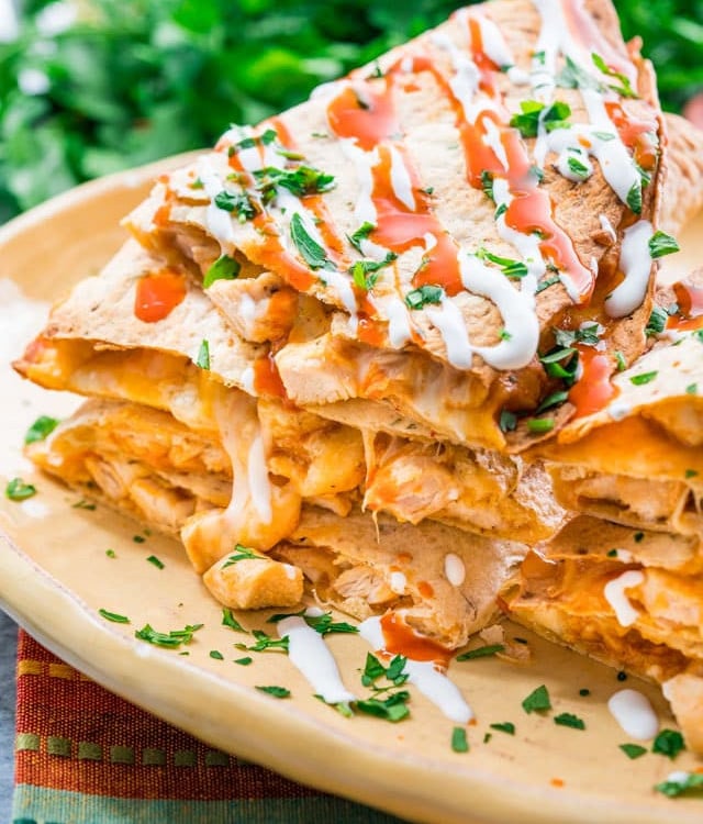 side view shot of a stack of buffalo chicken quesadillas on a plate