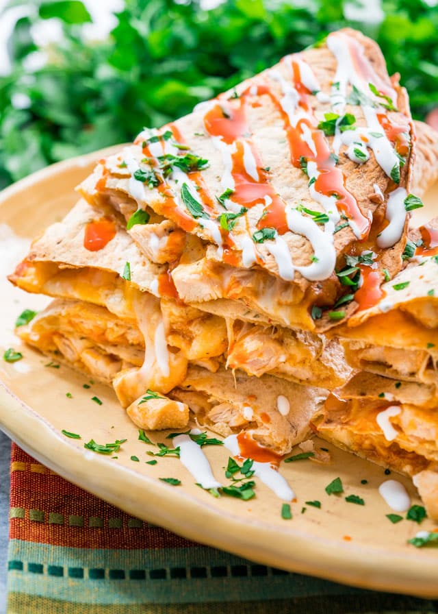 side view shot of a stack of buffalo chicken quesadillas on a plate