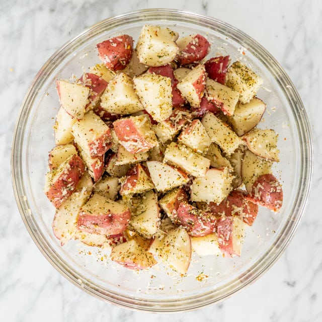 Italian Parmesan Roasted Potatoes in a bowl ready to be roasted