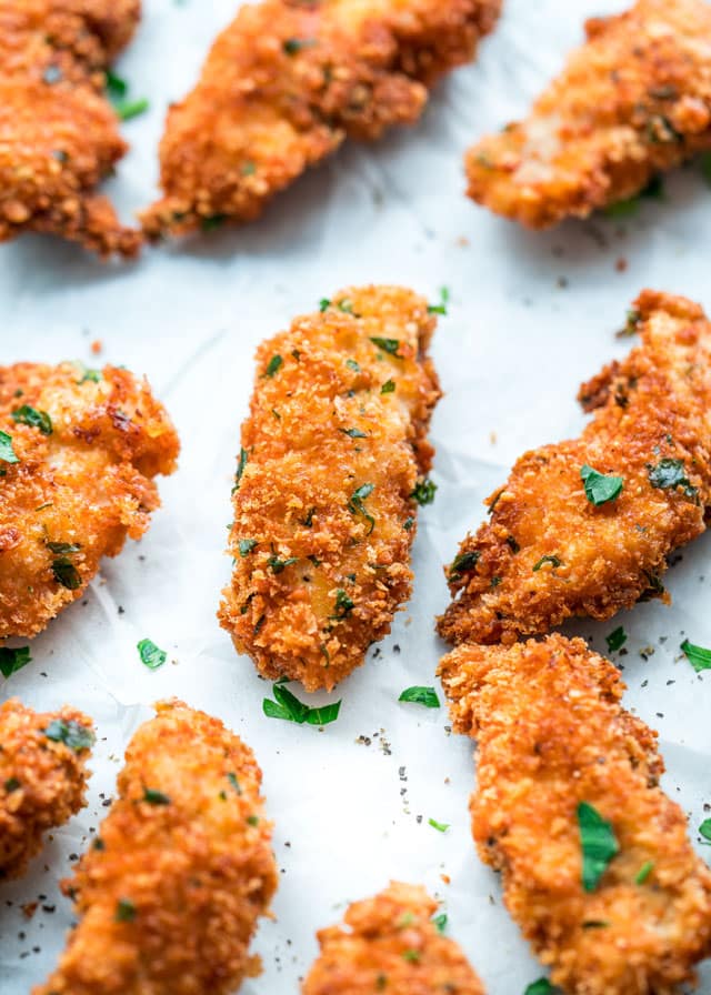 closeup of parmesan chicken strips with parsley