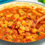 freshly made pork and potatoes in a skillet.