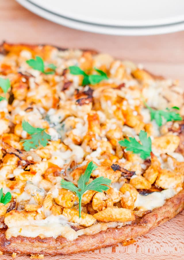 Close up shot of a Buffalo Chicken and Caramelized Onions Pizza on Cauliflower Crust