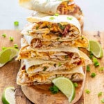 a stack of chicken quesadillas on a cutting board.