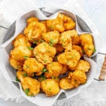 freshly made deep fried cauliflower in a metal basket.