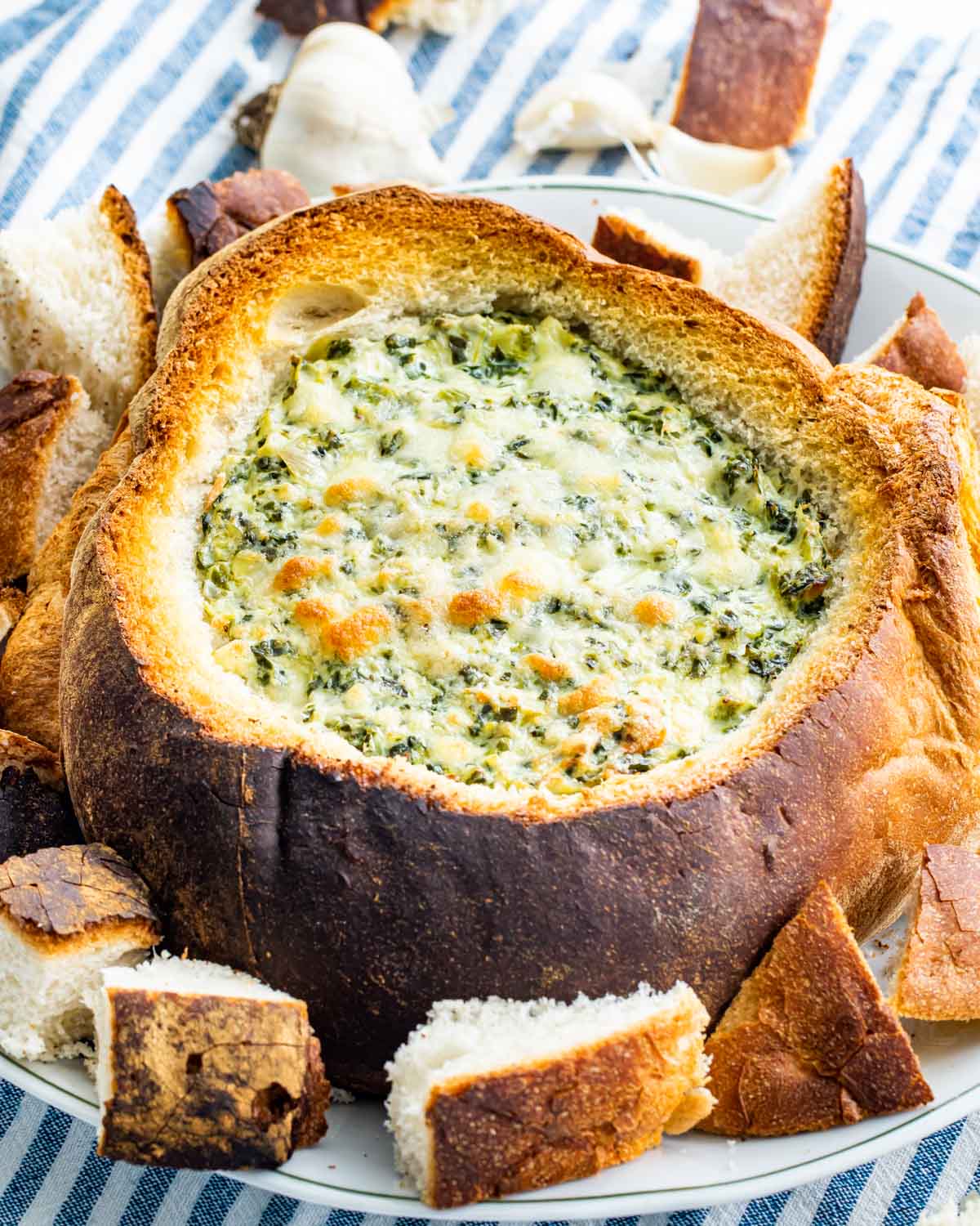 spinach and artichoke dip in a bread bowl.