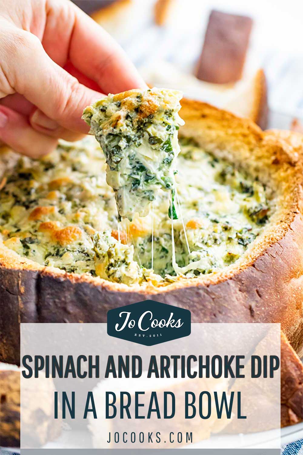 pin for spinach and artichoke dip in a bread bowl.