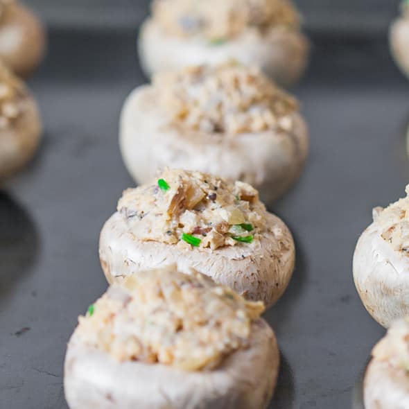 Close up of Bacon and Cream Cheese Stuffed Mushrooms being assembled