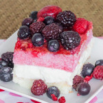 a berry cheesecake square topped with fresh berries