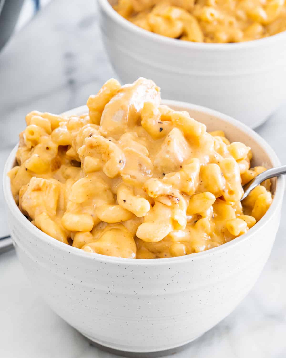 chicken mac and cheese in two white bowls