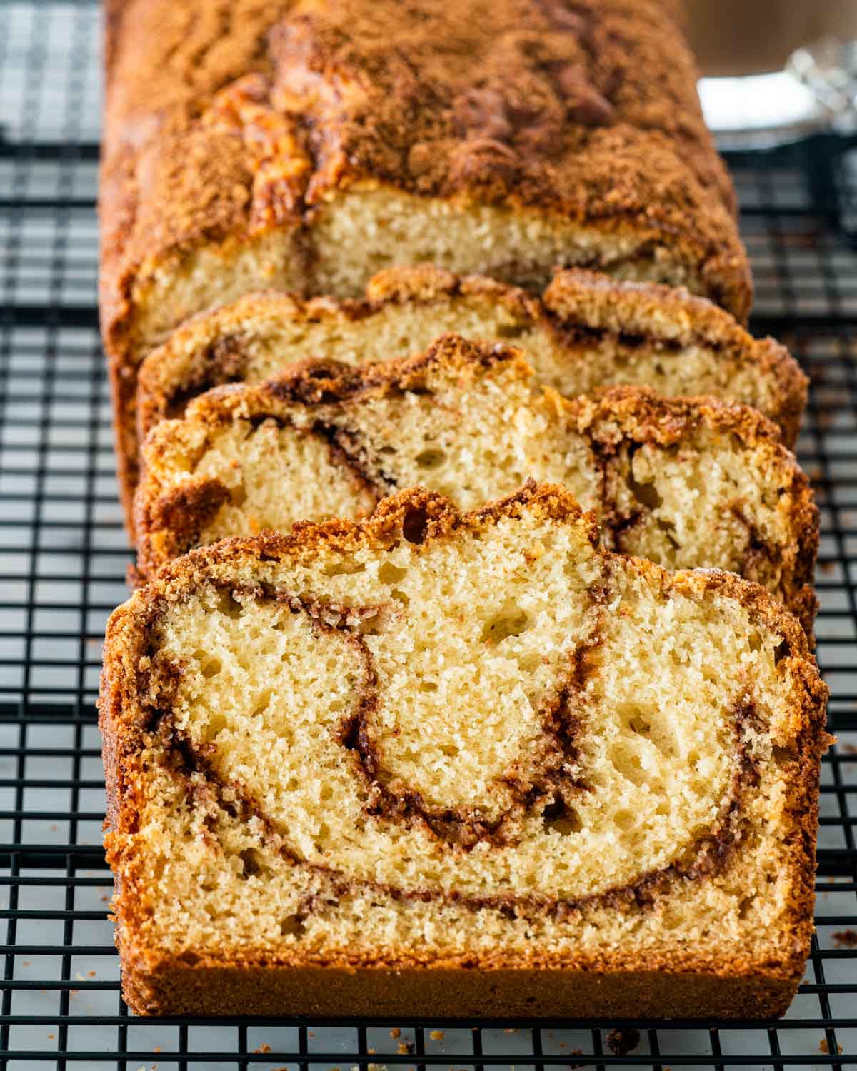 slices of freshly baked coffee cake bread on a cooling rack.