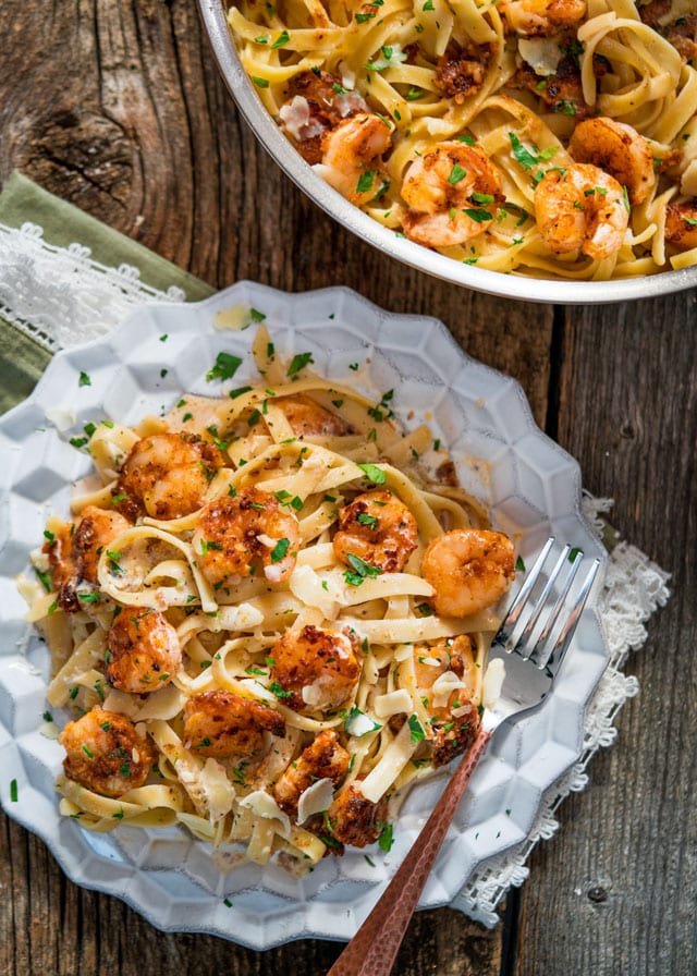 overhead of a plate of shrimp and fettuccine with a fork