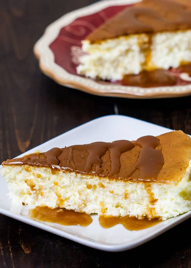 Japanese Cheesecake slice drizzled with caramel sauce on a white plate