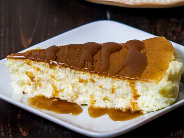Japanese Cheesecake on a white plate drizzled with caramel sauce