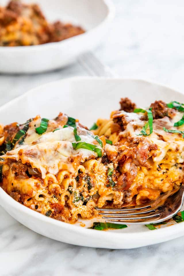 two lasagna roll-ups on a white plate