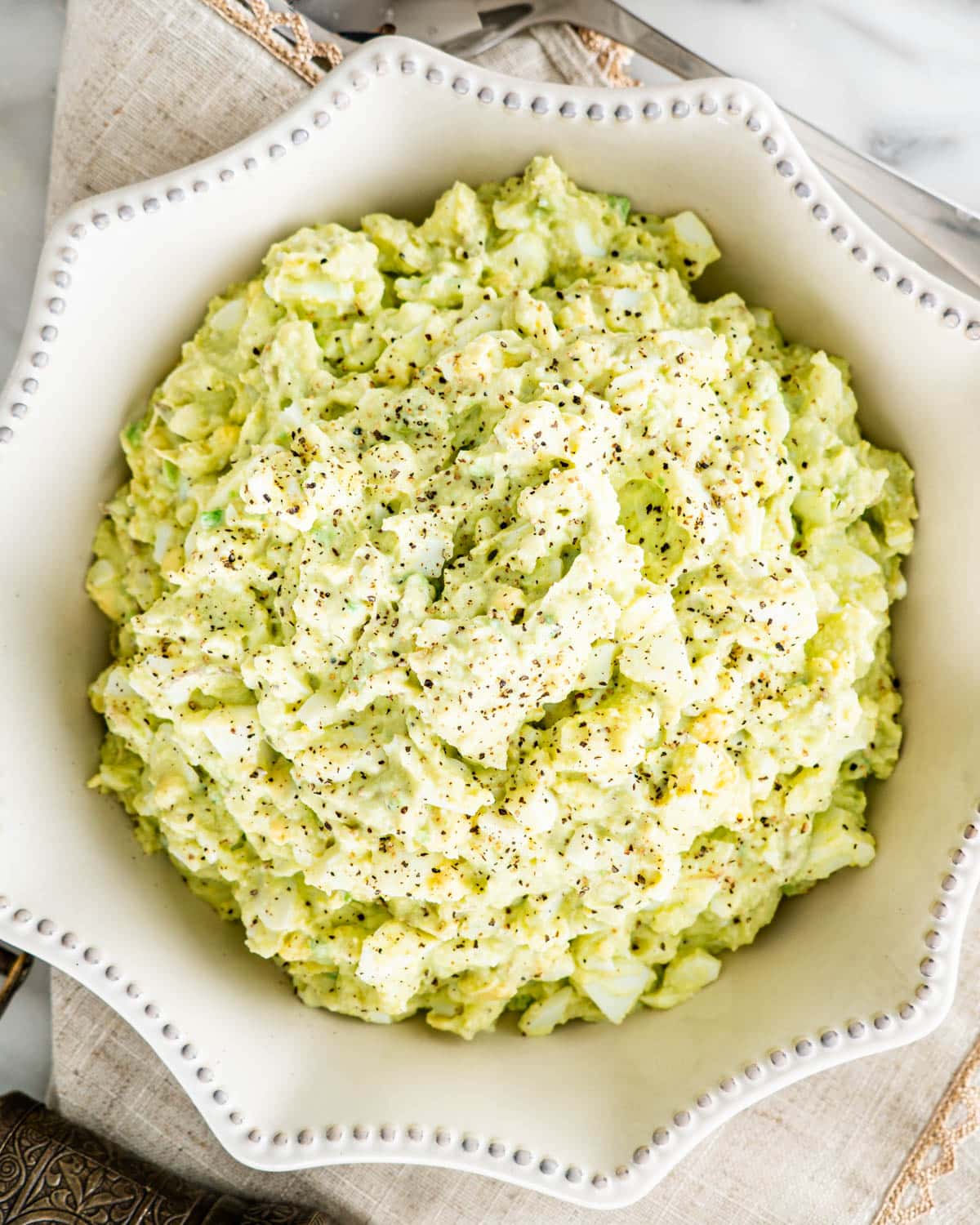 overhead shot of a bowl filled with avocado egg salad
