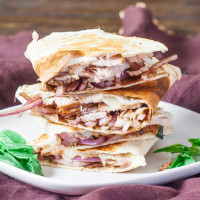 pork and balsamic onion quesadillas stacked on a plate