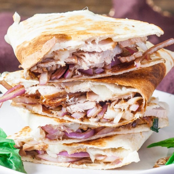 pork and balsamic onion quesadillas stacked on a plate