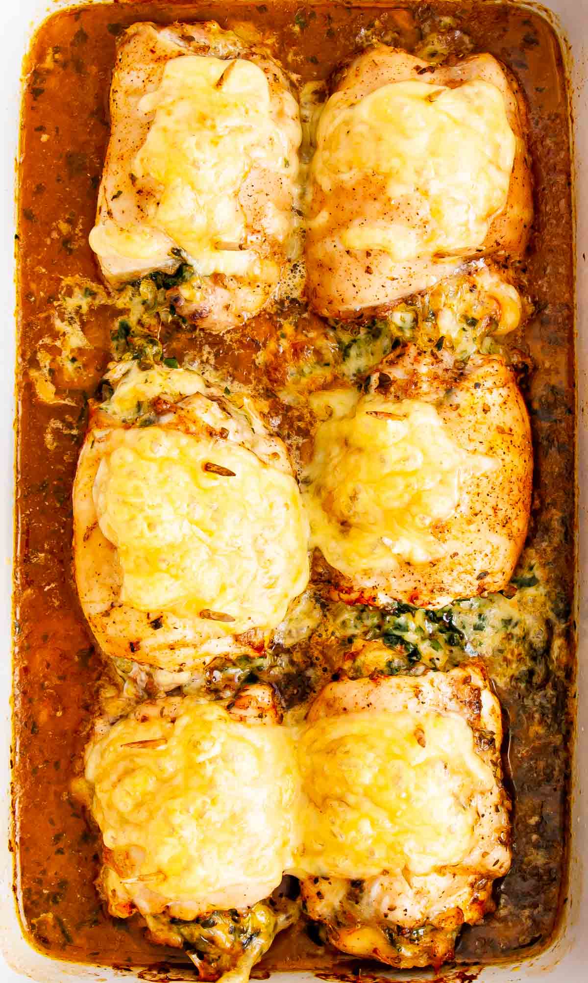overhead shot of stuffed chicken thighs with spinach and cheese fresh out of the oven