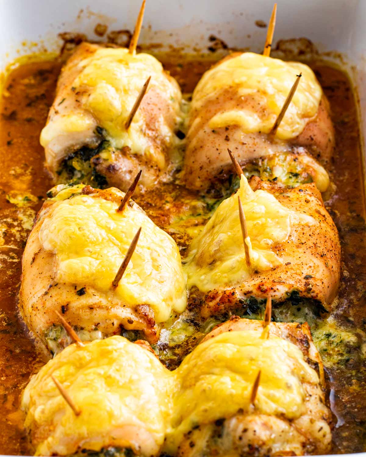 side view shot of stuffed chicken thighs with spinach and cheese fresh out of the oven