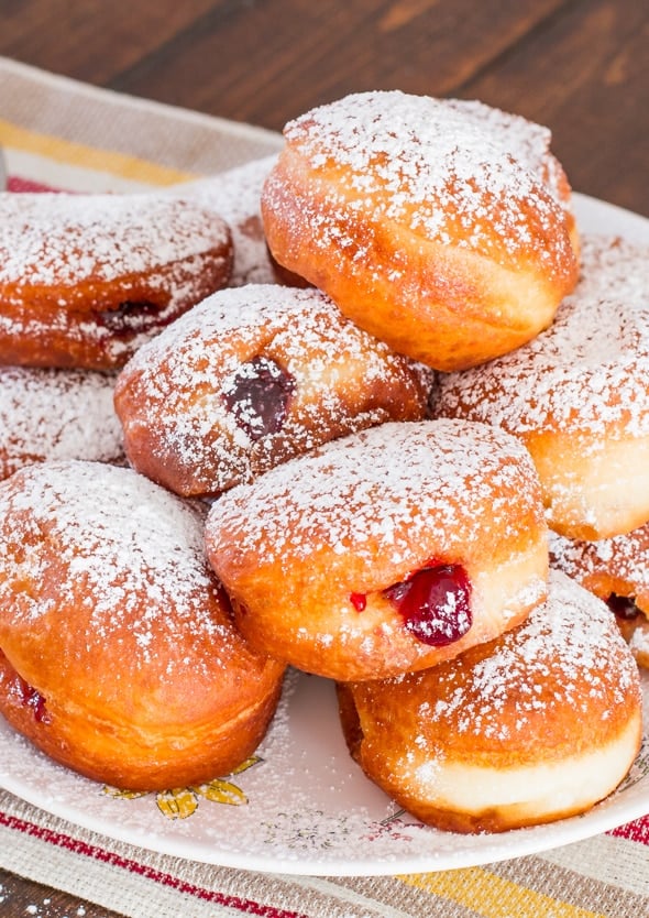 Close up shot of Cherry Jam Filled Sour Cream Donuts dusted with powdered sugar