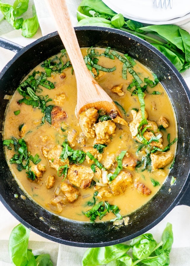 Coconut Basil Chicken Curry in a black skillet