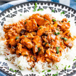 mushroom chicken paprikash over a bed of rice garnished with parsley.