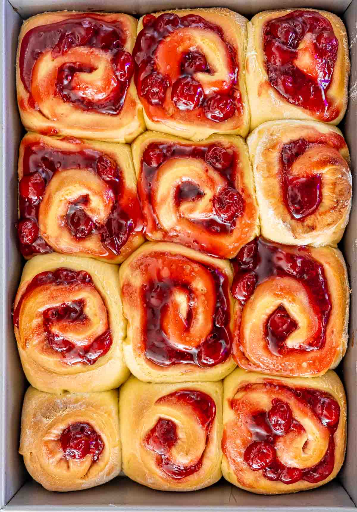 cherry rolls in a baking pan fresh out of the oven.