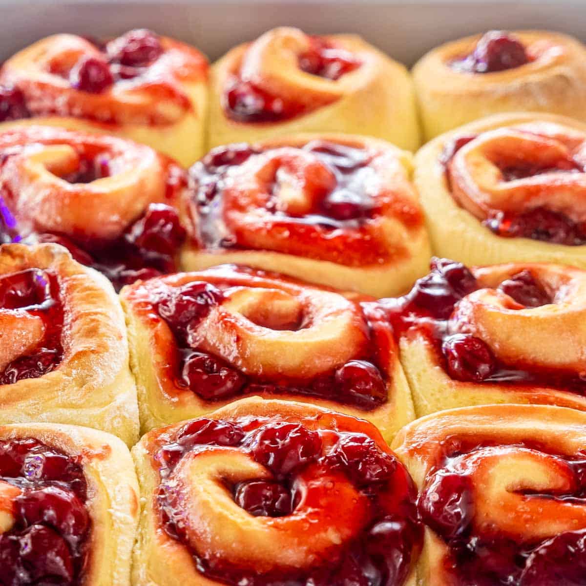 cherry rolls in a baking pan fresh out of the oven.