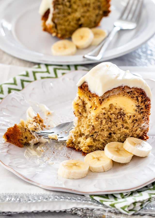 a slice of Cream Cheese Filled Cake on a plate with fork and banana slices