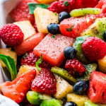 close up shot of mixed fruit with lemon basil dressing
