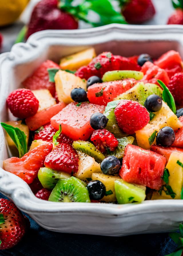 a large serving bowl filled with fruit salad