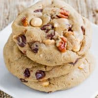 a stack of butterscotch chocolate and pecan cookies on a plate