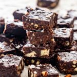 pieces of microwave chocolate fudge on a piece of parchment paper.