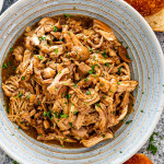 brown sugar pulled pork in a blue plate.