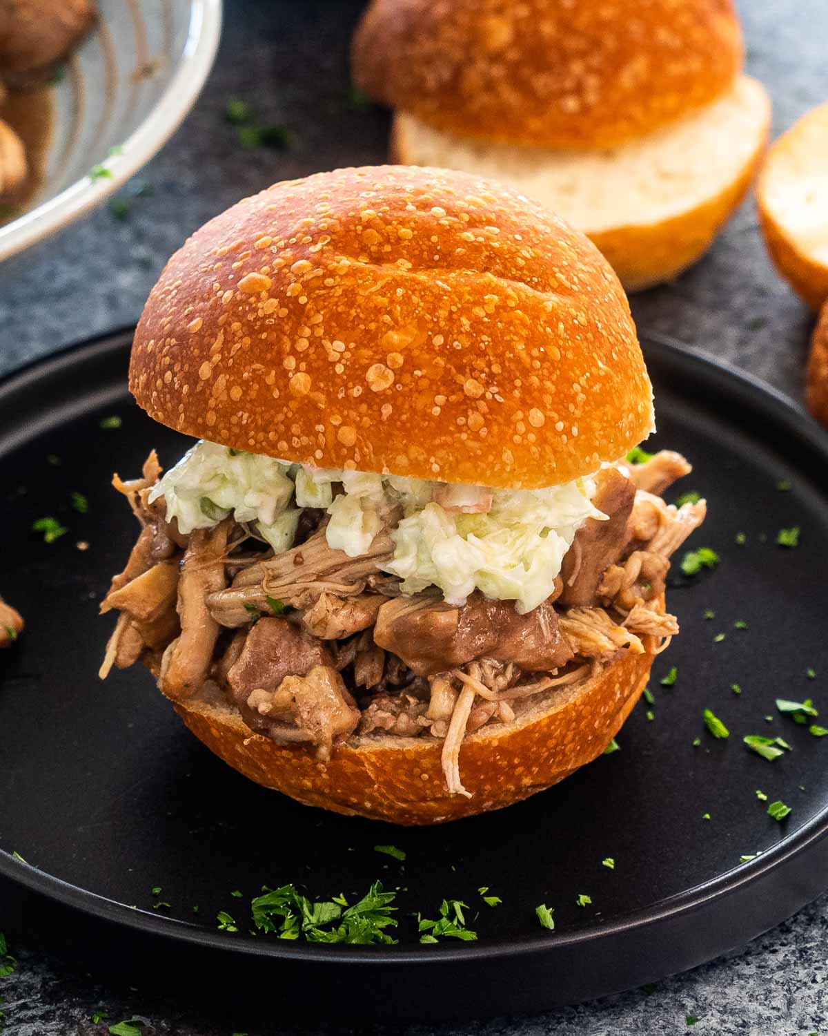 a bun with brown sugar pulled pork and coleslaw.