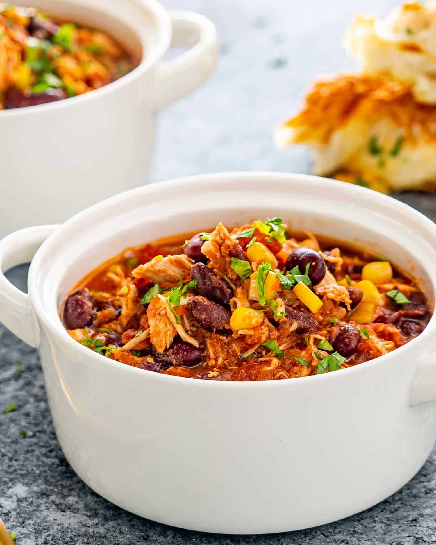 slow cooker chicken chili in a white bowl.